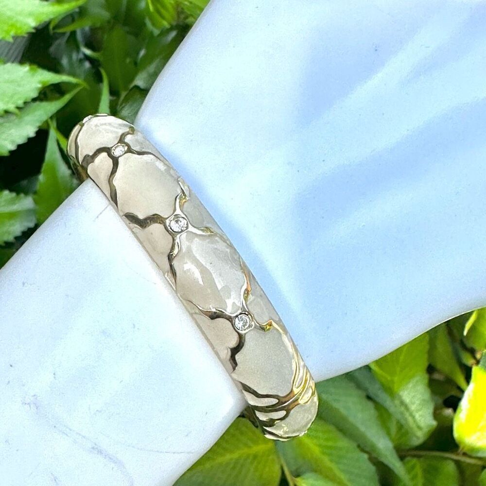 Cream  enamel and gold tone  rhinestone hinged bangle bracelet